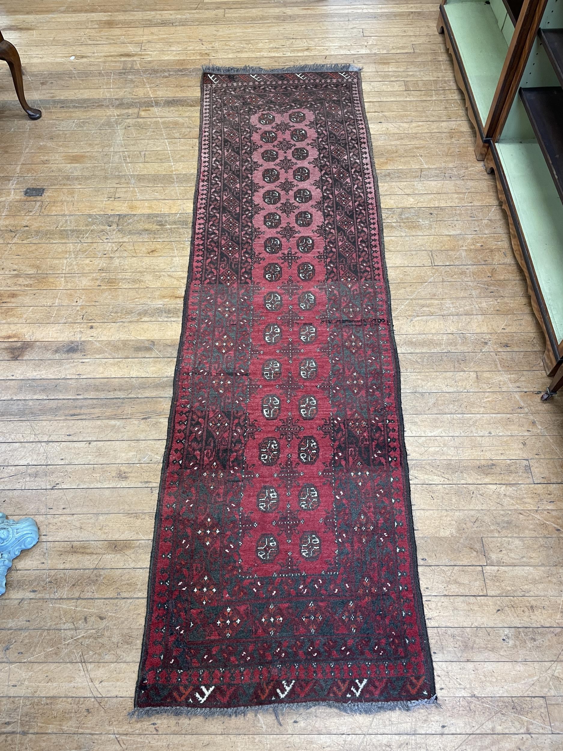 An Afghan red ground rug, 166 x 109 cm