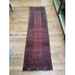 An Afghan red ground rug, 166 x 109 cm