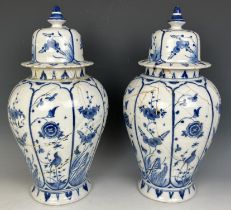 A pair of Delft blue and white vases and covers, 45 cm high