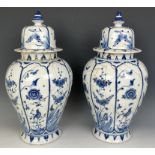 A pair of Delft blue and white vases and covers, 45 cm high