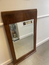 An Art Deco wall mirror, in a walnut frame, 123 x 75 cm