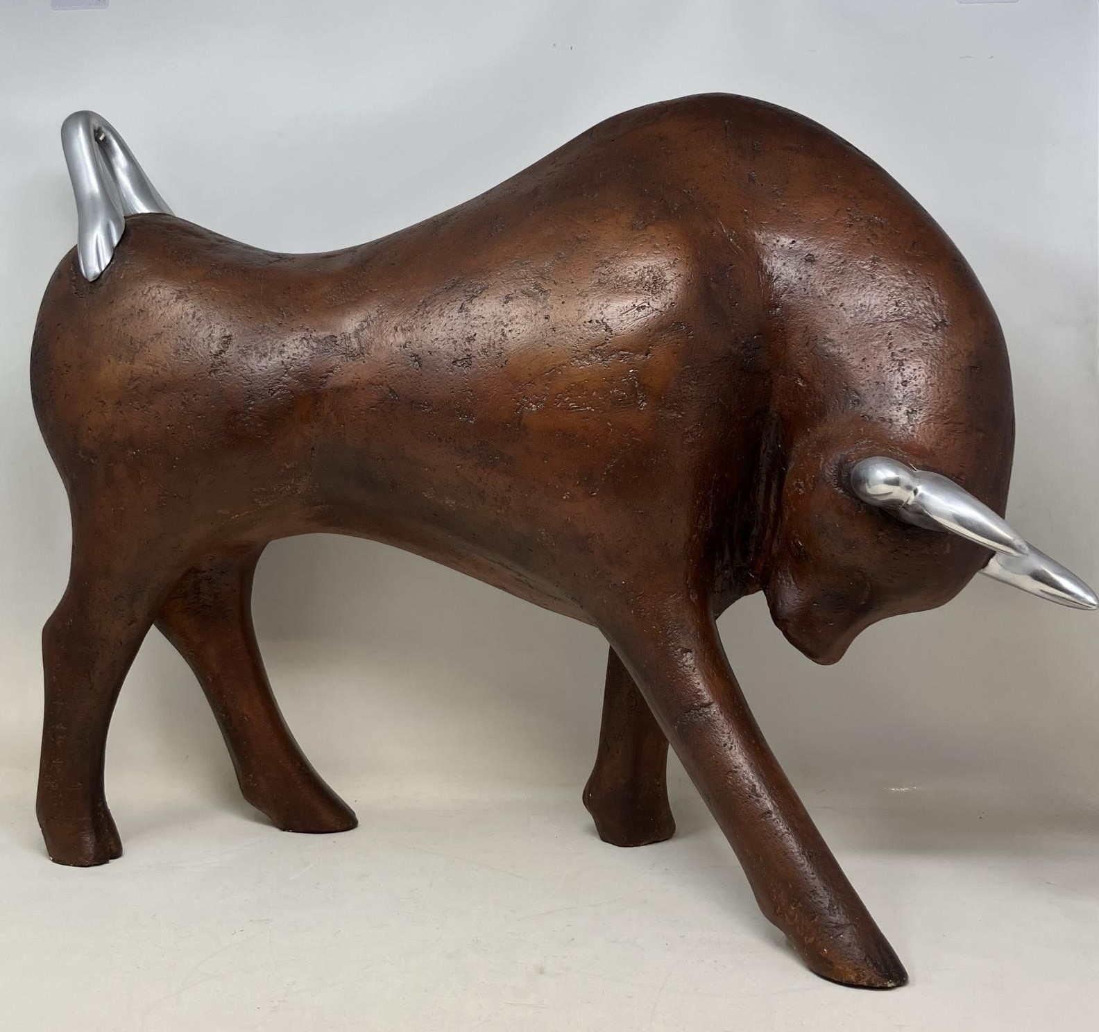A modern figure of a bull, assorted African carvings, and a Continental silver coloured metal tea