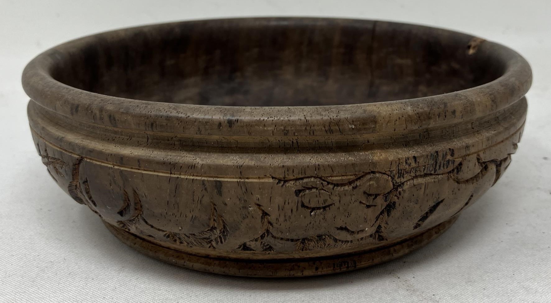 An African carved wooden bowl, 17 cm diameter, and a candle stand, probably from Makonde, 19 cm high - Image 2 of 3