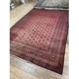 A red ground Afghan type carpet, 290 x 203 cm, a yellow ground rug, 175 x 130 cm and a red ground