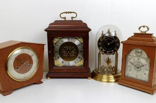 A reproduction mantel clock, in a mahogany case, 38 cm high, and three other clocks (4)