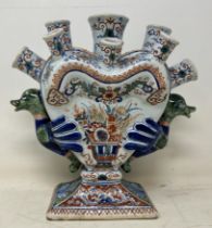 A 19th century Delft pottery tulip vase, with polychrome decoration and bird handles, 21.5 cm high