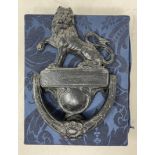 A late Victorian cast iron door knocker, with a lion finial, 25 x 16 cm