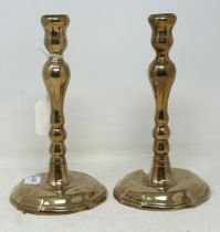 A pair of 18th century style candlesticks, on shaped circular bases, 21 cm high (2)