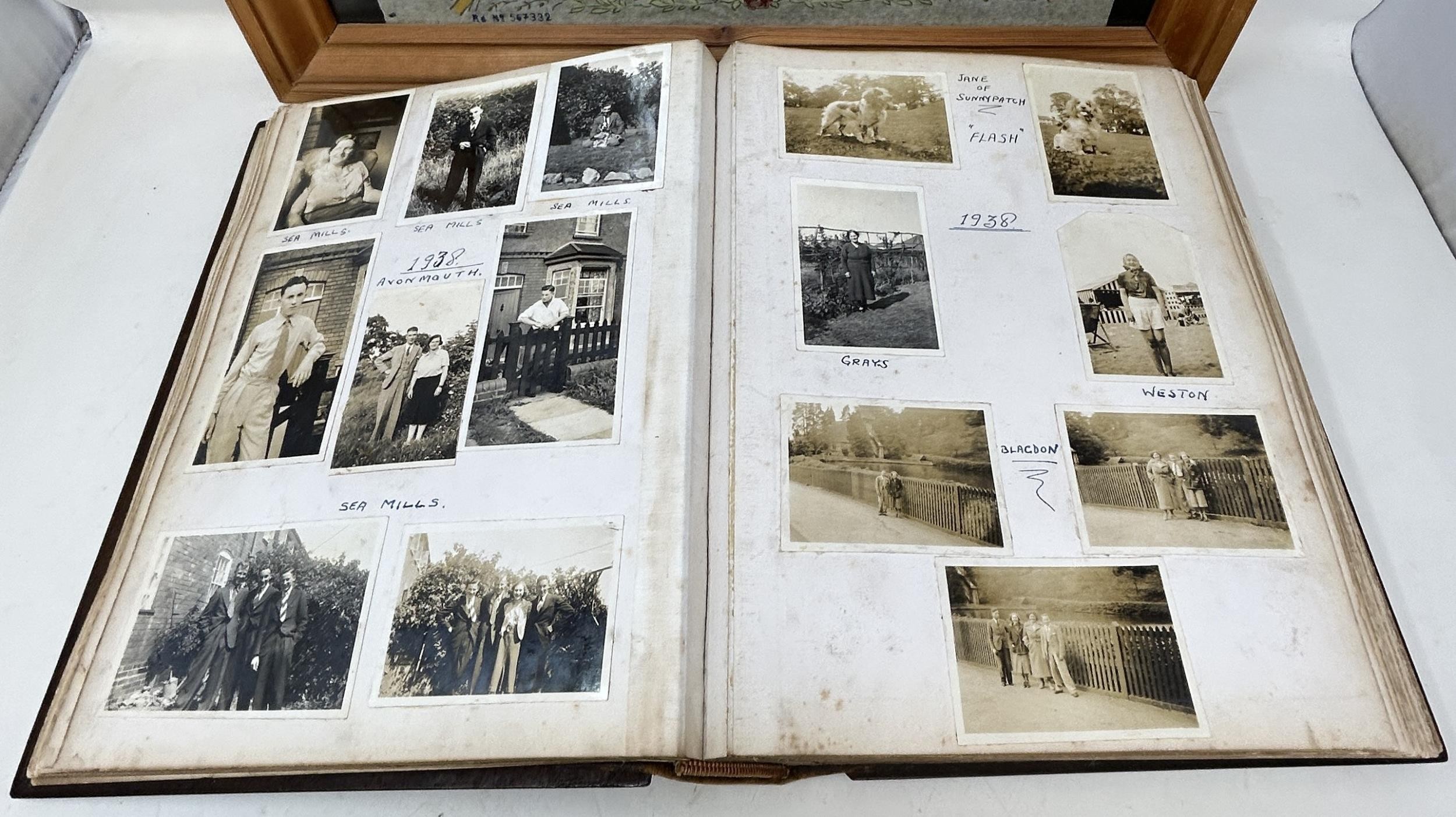 An early 20th century photograph album, with a carved wooden cover, contents of family portraits and - Image 2 of 5