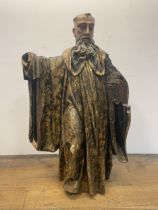 A large carved wood figure of a saint, with painted decoration, 119 cm high, possibly 16th century