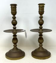 A pair of Dutch 17th century style brass candlesticks, with wide drip pans, 30 cm high (2)