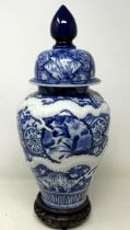 A Japanese blue and white vase and cover, on a stand, 38 cm high