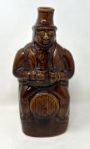 A 19th century brown glazed novelty bottle, 22 cm high