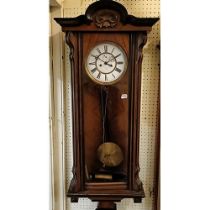 A Vienna regulator wall clock, with an enameled dial, subsidiary seconds dial, to a twin train eight