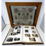 An early 20th century photograph album, with a carved wooden cover, contents of family portraits and