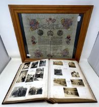 An early 20th century photograph album, with a carved wooden cover, contents of family portraits and