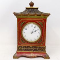 A mantel clock, with Arabic numerals, in a red case with Chinoiserie style decoration, 26 cm high