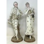 A pair of Continental figures, of a gentleman and a lady, 40 cm high, and a pair of floral encrusted