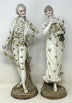 A pair of Continental figures, of a gentleman and a lady, 40 cm high, and a pair of floral encrusted