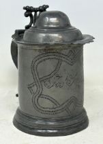 A 19th century pewter lidded tankard, inscribed Josh Smith, and with wrigglework decoration, 18 cm