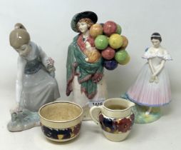 A Royal Doulton figure, the Balloon Seller HN583, another La Sylphide HN2138, a Lladro figure, and a