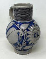 An 18th century German Westerwald stoneware jug, with GR cypher, 22 cm high