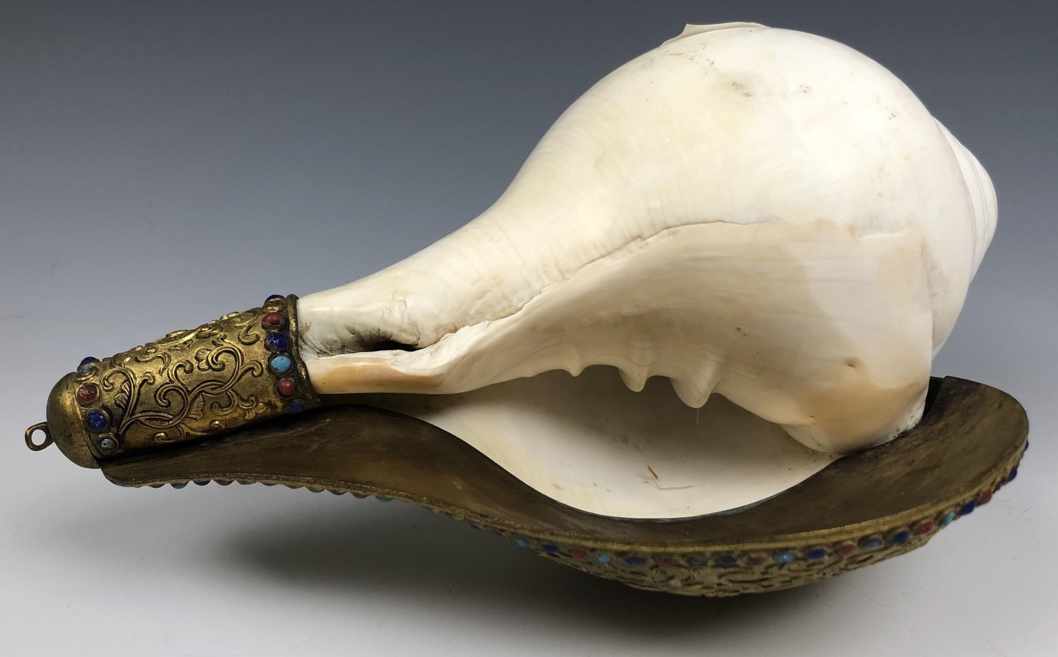 A Chinese conch shell trumpet, with a gilt bronze flange decorated in relief, with the eight - Image 5 of 6