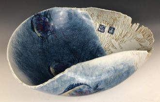 A modern Japanese art pottery bowl, of irregular form, decorated fish, signed, 46 cm wide