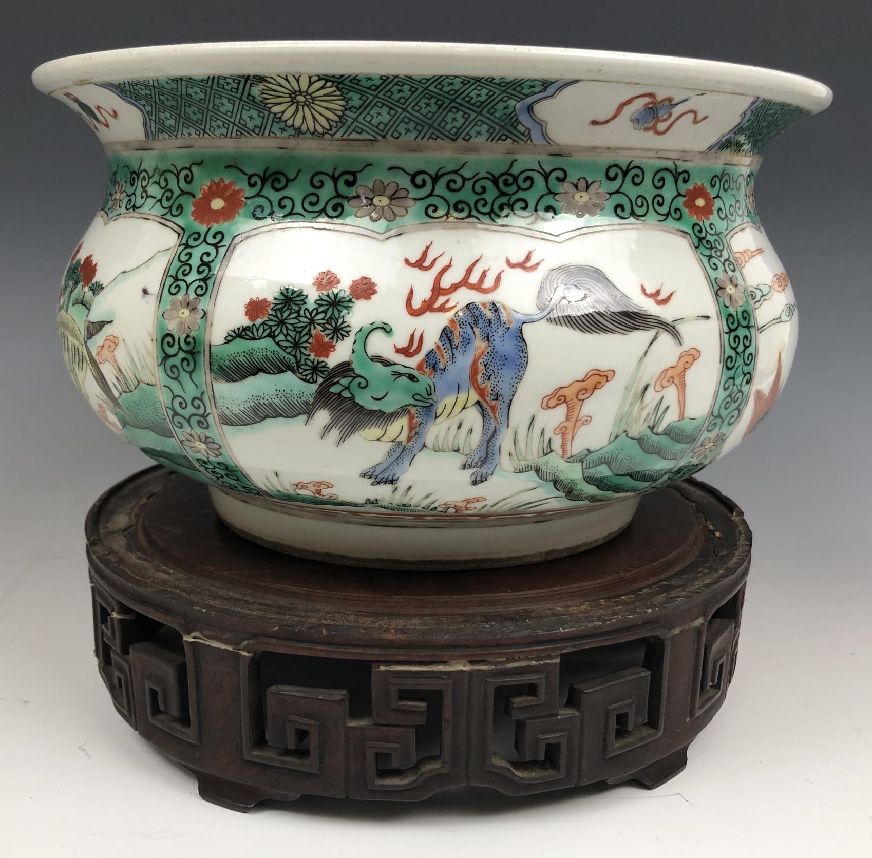 A Chinese famille verte bowl, decorated beasts, six character mark to base, 20 cm diameter, on a