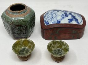 A pair of green stone bowls, on stands, 7.5 cm diameter, a green glazed ginger jar, and a laquered