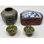 A pair of green stone bowls, on stands, 7.5 cm diameter, a green glazed ginger jar, and a laquered