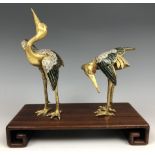 A pair of Chinese cloisonné figures of cranes, probably Qing Dynasty, 18th century, on an associated