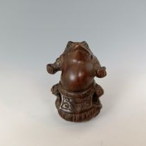 A carved wooden netsuke, in the form of a frog, signed 5 cm wide