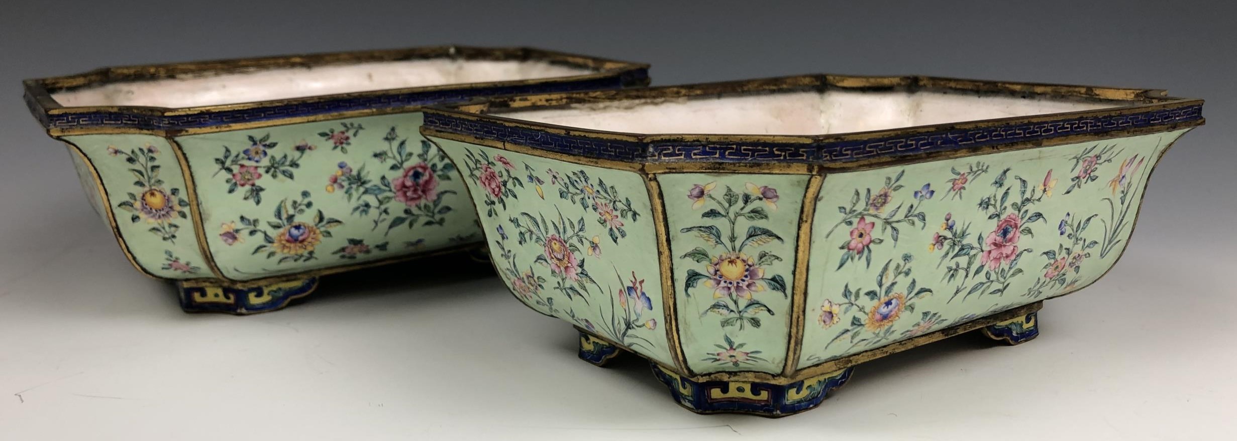 A pair of Chinese Canton enamel jardinieres, decorated flowers on a pale green ground, 19.5 cm