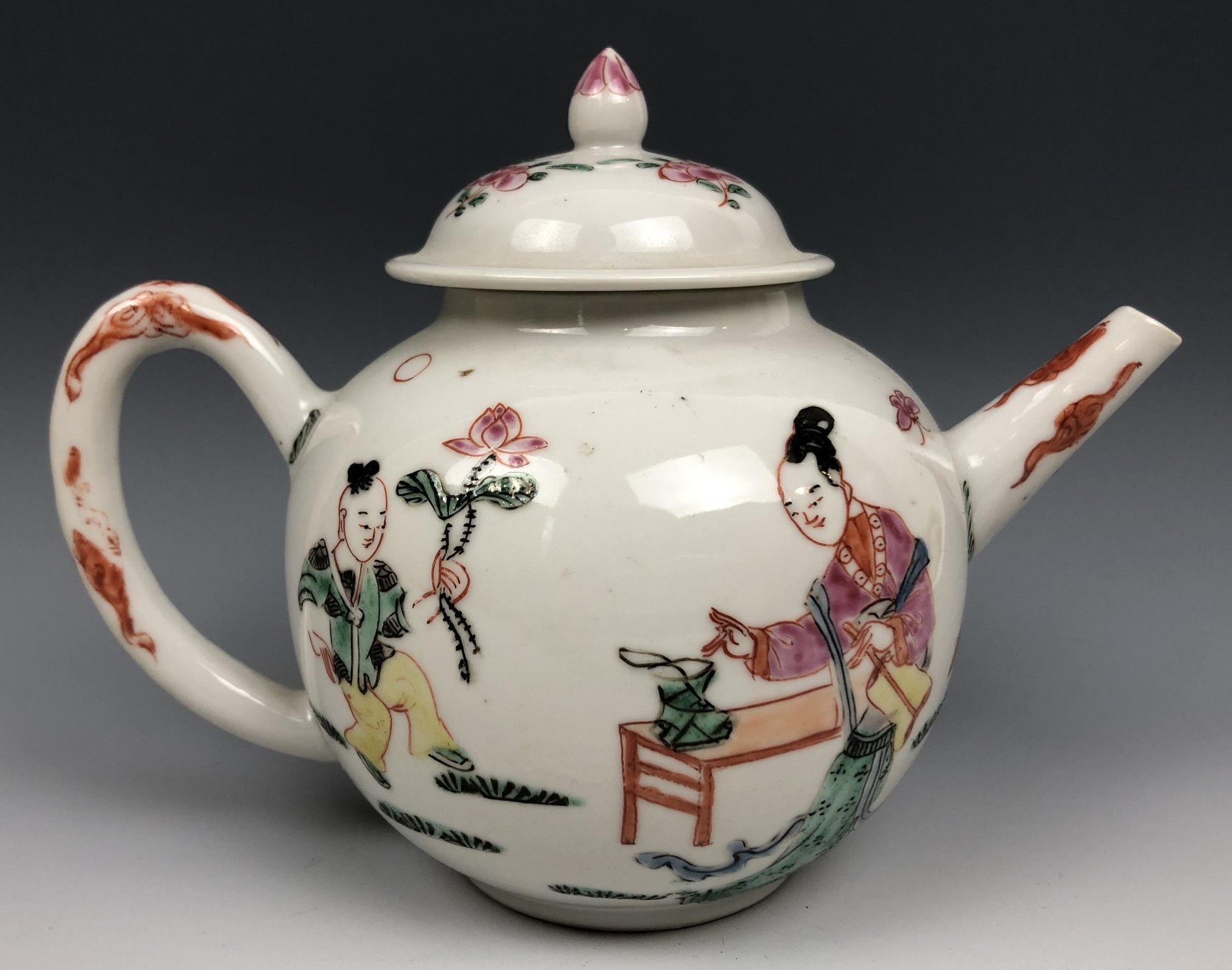 A Chinese famille rose teapot and cover, decorated figures, 12 cm high very minor spout chips