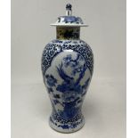 A Chinese blue and white vase and cover, decorated bird and foliage, four character mark to base, 30