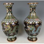 A pair of cloisonné vases, decorated dragons, 24 cm high, a cloisonné bowl, and a brass scallop