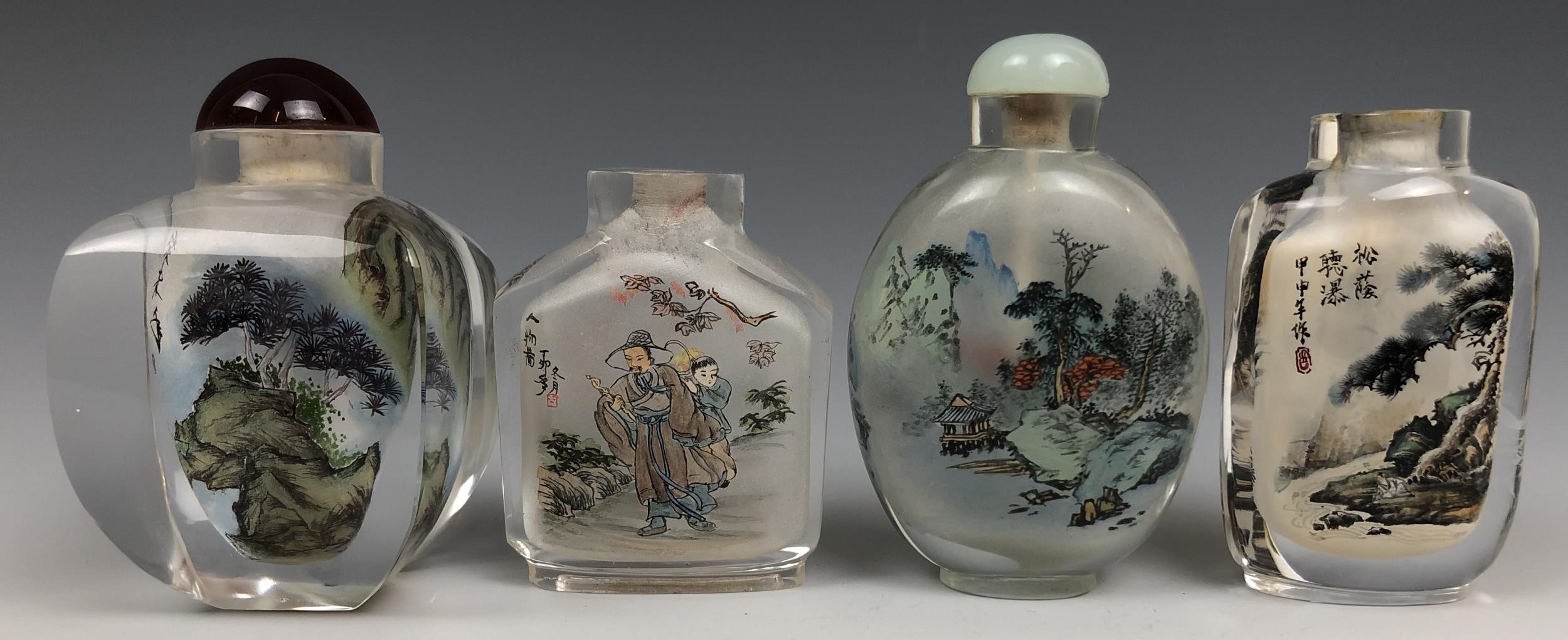 A Chinese glass snuff bottle, interior painted a landscape, 8 cm high, and three others