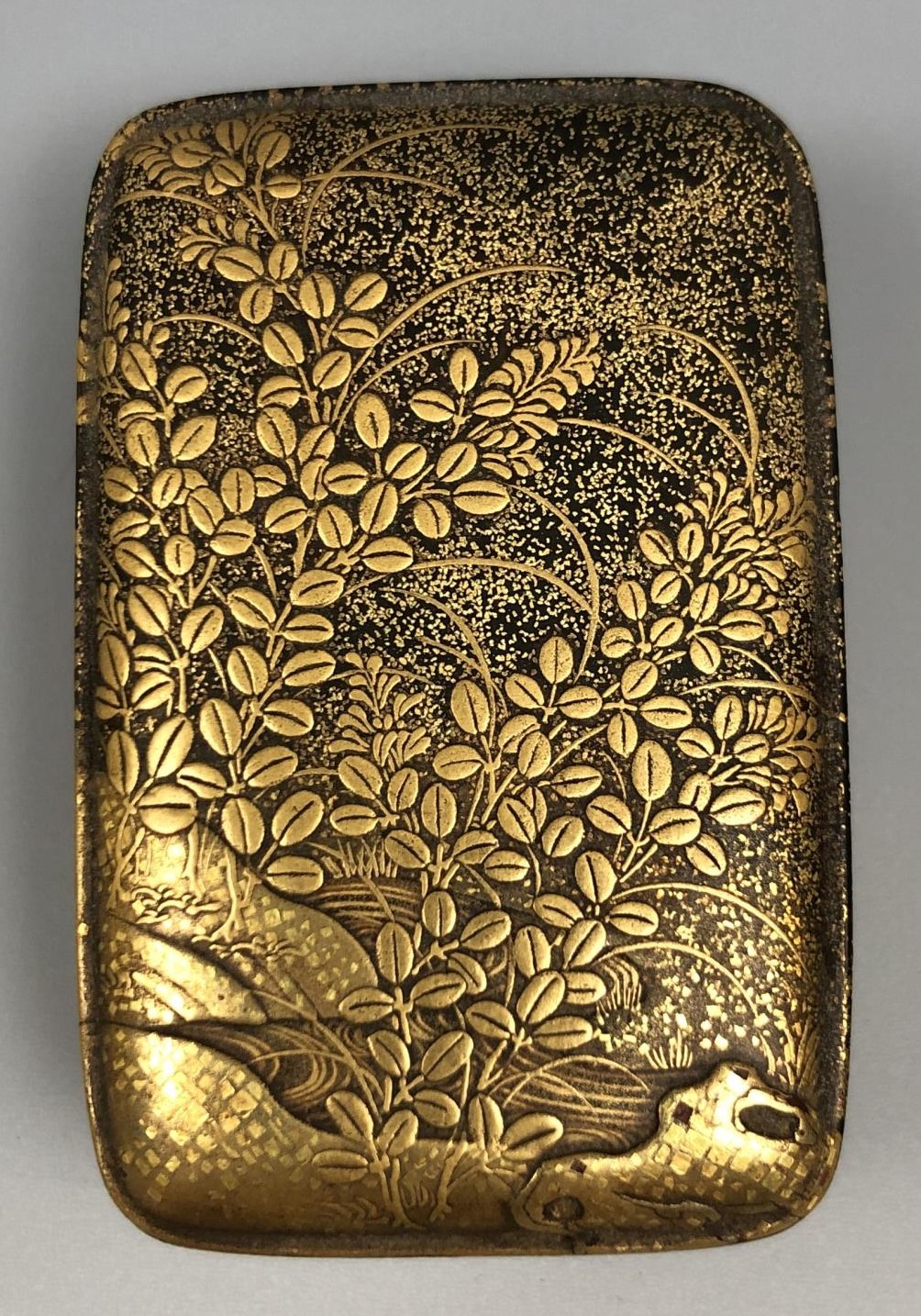 A Japanese lacquered box and cover, decorated flowers and foliage, 5 cm wide