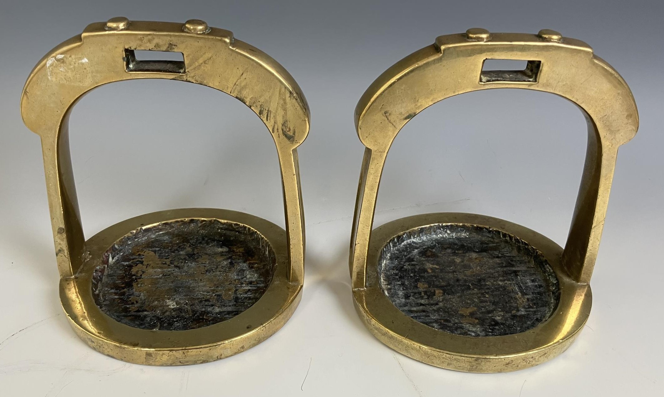 A pair of Chinese brass horse stirrups, 15.5 cm high (2)