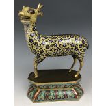 A Chinese cloisonné figure of a stag, standing on a lotus leaf style base, probably Qing Dynasty,