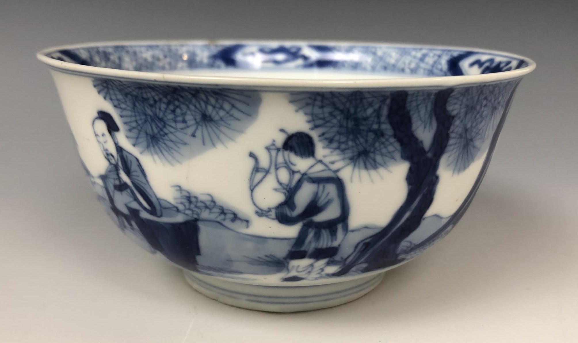 A Chinese porcelain bowl, decorated figures in a landsape, six character mark to the base, 11.5 cm