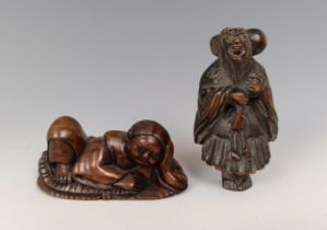 A carved wooden netsuke, in the form of a reclining figure, signed, 5 cm wide, and another of a