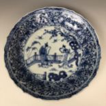 A pair of Chinese shallow dishes, decorated figures and foliage in underglaze blue, 21 cm