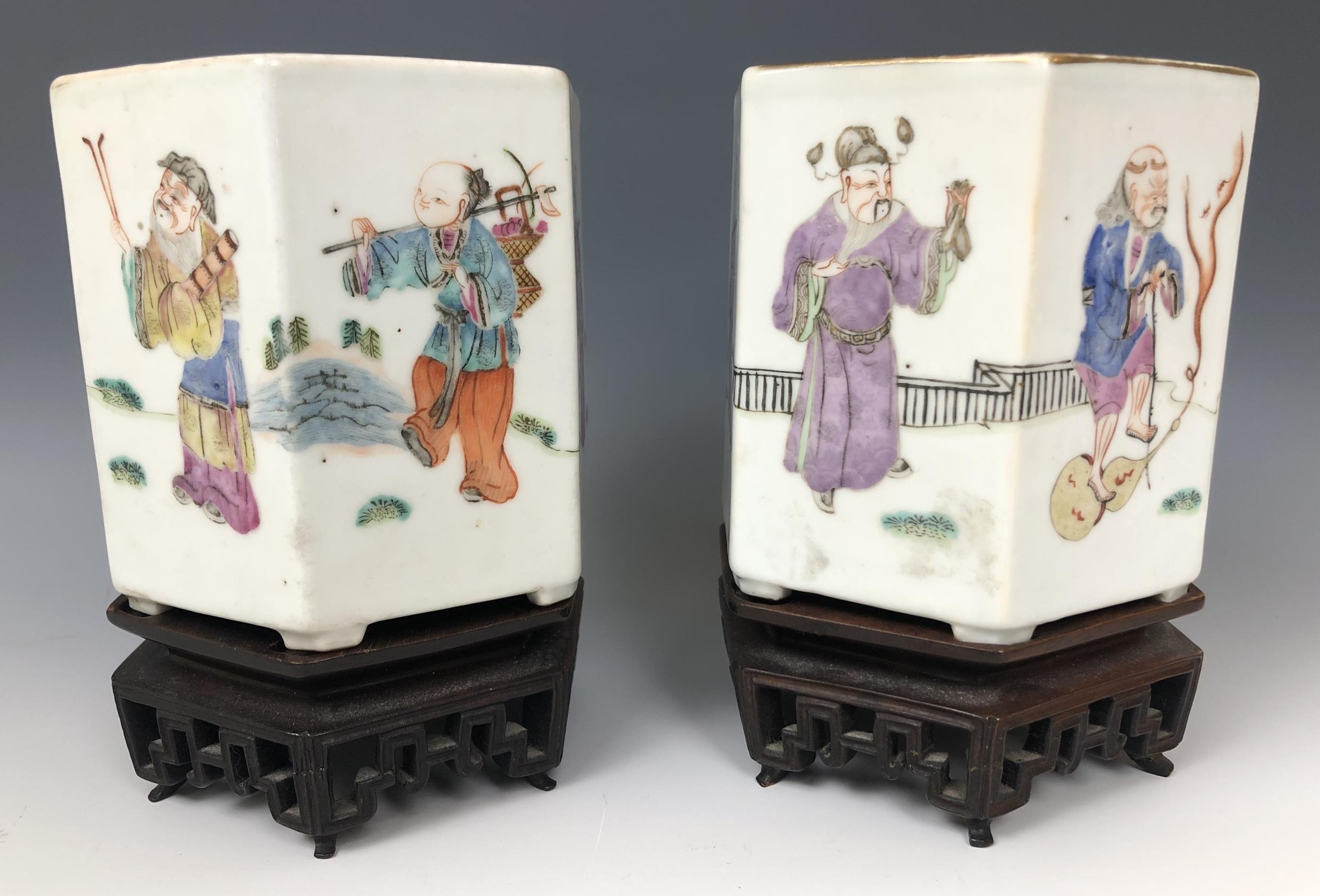 A pair of Chinese hexagonal vases, decorated various figures in famille rose colours, seal mark to