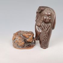 A carved wooden netsuke, in the form of a dragon, 4 cm wide, and another of a figure, 7 cm (2)