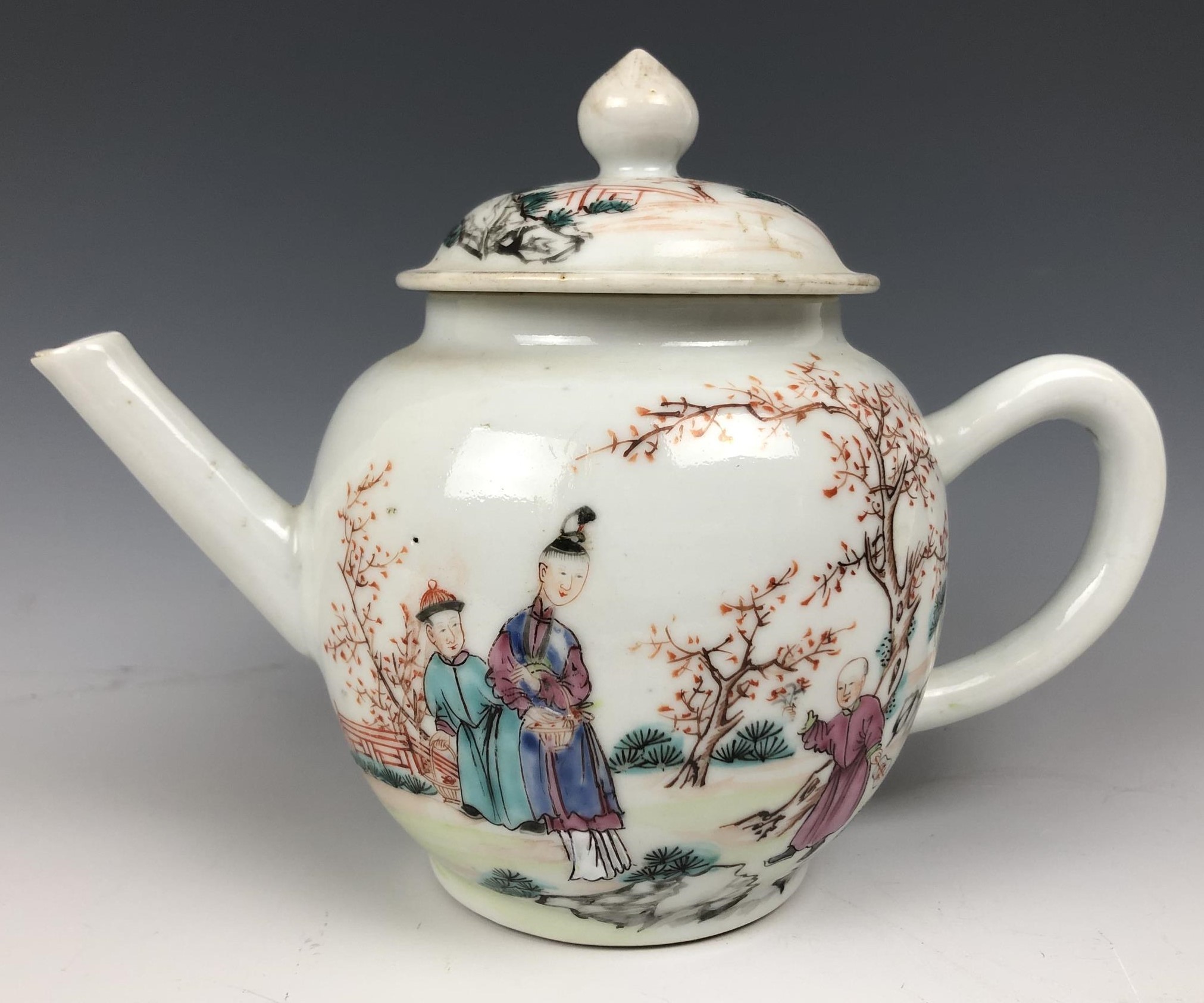 A Chinese famille rose teapot and cover, decorated figures, 13.5 cm high no visible chips or cracks,