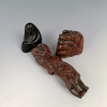A carved wooden netsuke, in the form of a man, 9 cm, another in the form of a woman, 4 cm, and