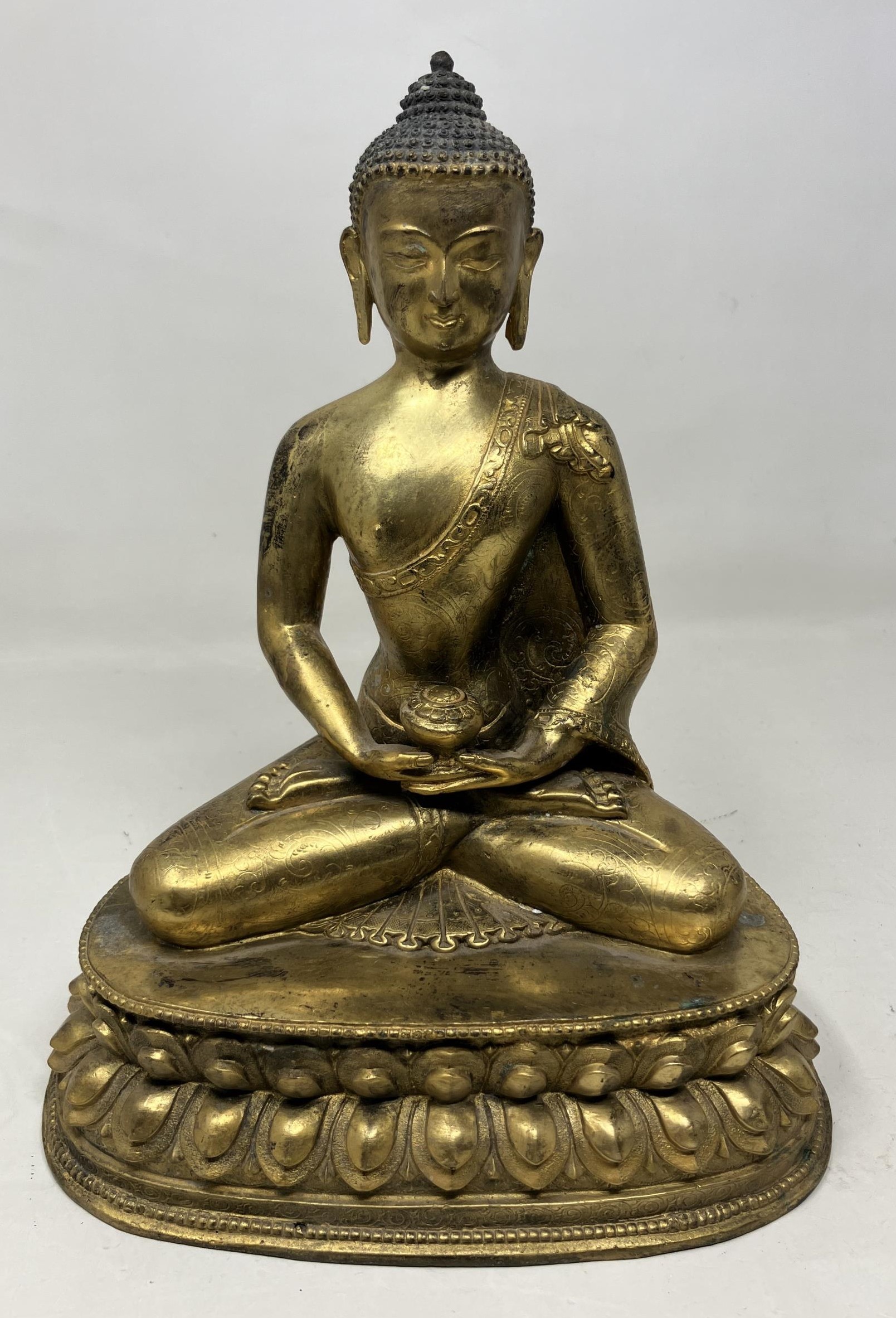 A gilt bronze Buddha, 25 cm high with a receipt