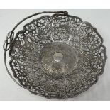 A Chinese silver coloured metal swing handled basket, with a simulated bamboo handle, the base